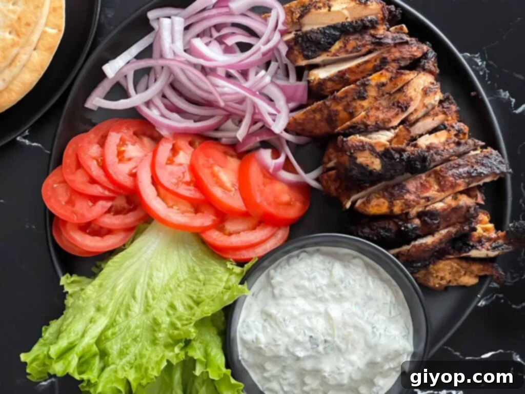 Grilled chicken shawarma on a dark plate.