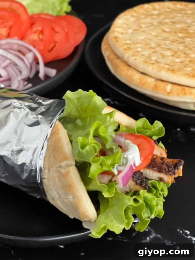 Grilled chicken shawarma on a dark plate.