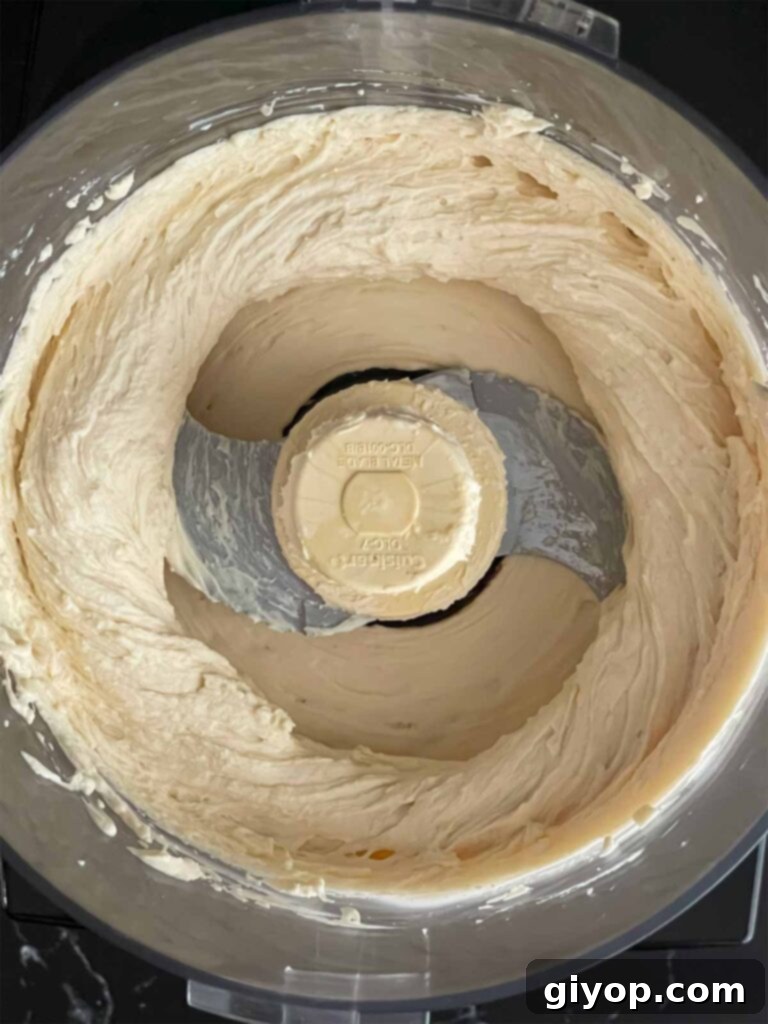 Ricotta mousse whipped in the bowl of a food processor.