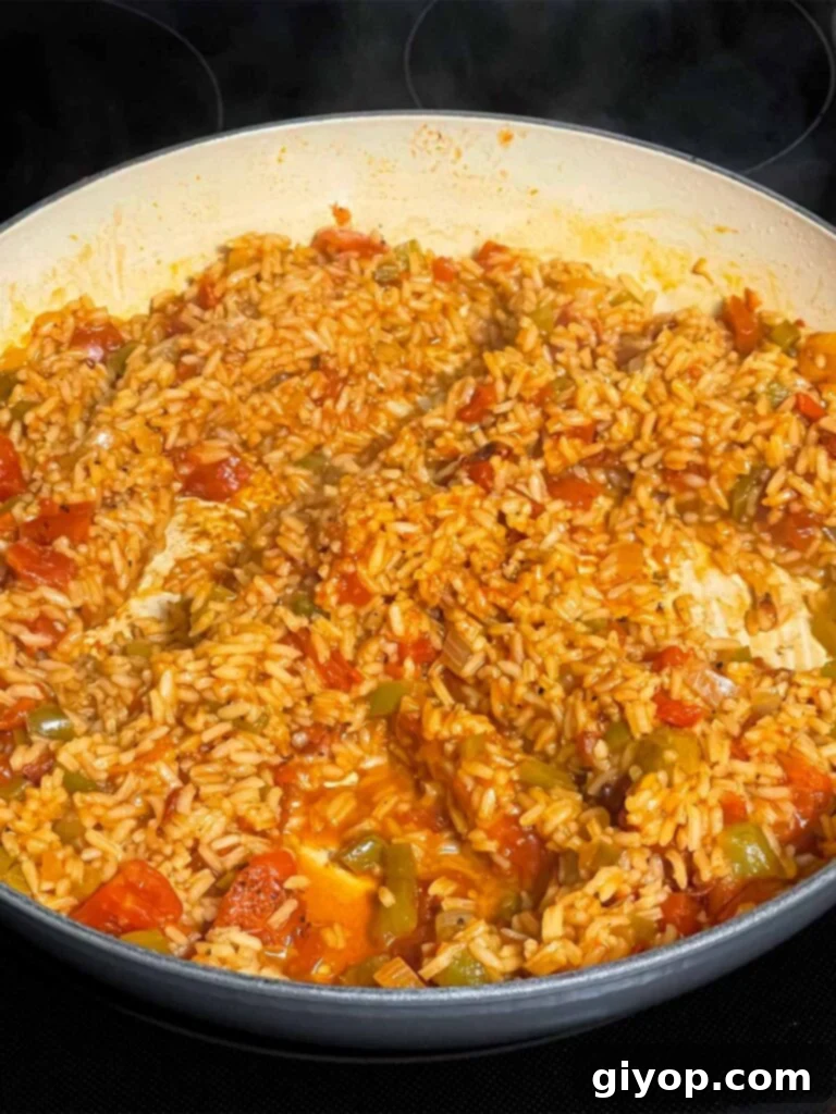 Cooked Spanish rice in a skillet.