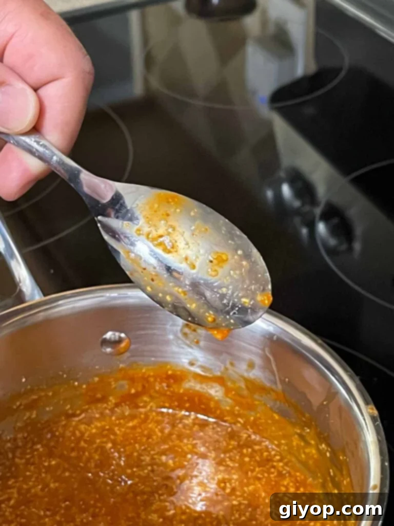 Testing the thickness of the Carolina barbecue sauce on the back of a spoon.
