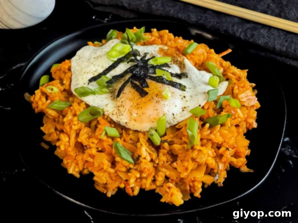 Kimchi fried rice topped with green onion, and gim.
