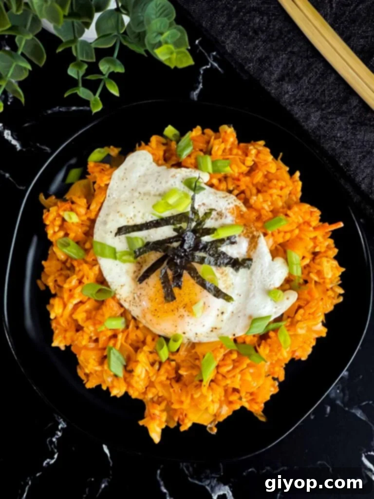 Kimchi fried rice topped with green onion, and gim.