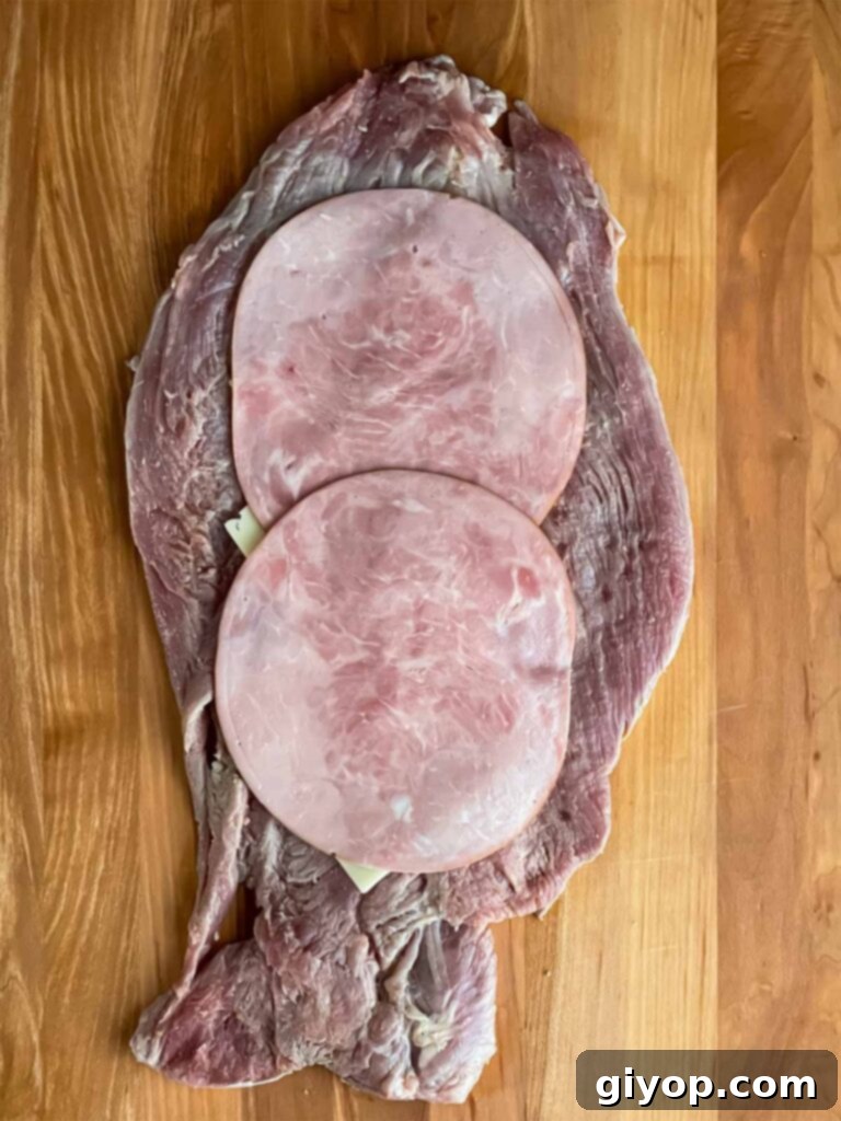 Grilled Mojo Pork Roulade 8 Layers of deli ham and Swiss cheese arranged on the flattened pork tenderloin.