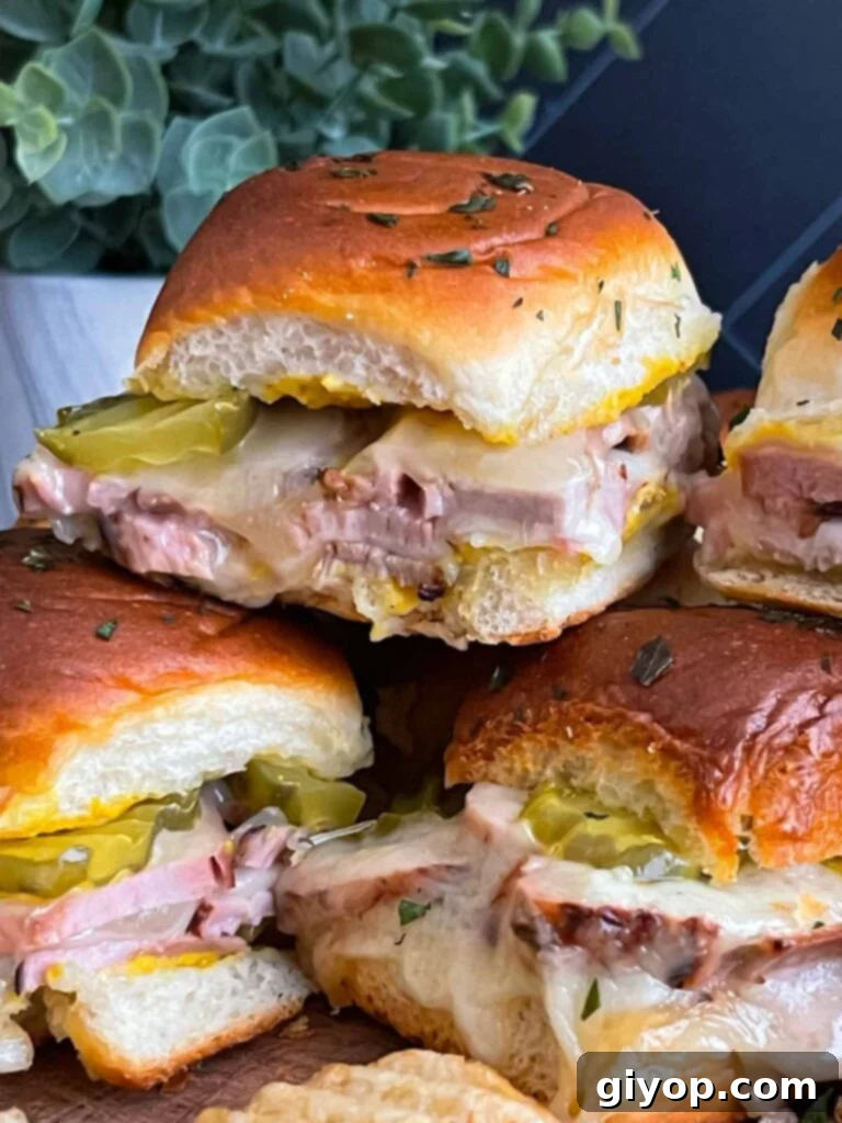 A serving platter filled with finished roll-cut pork tenderloin Cuban sliders, ready to be enjoyed.