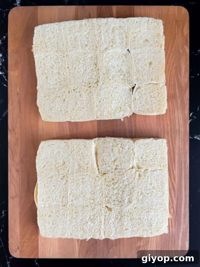 Slider buns cut in half on a wooden cutting board, ready for assembly.