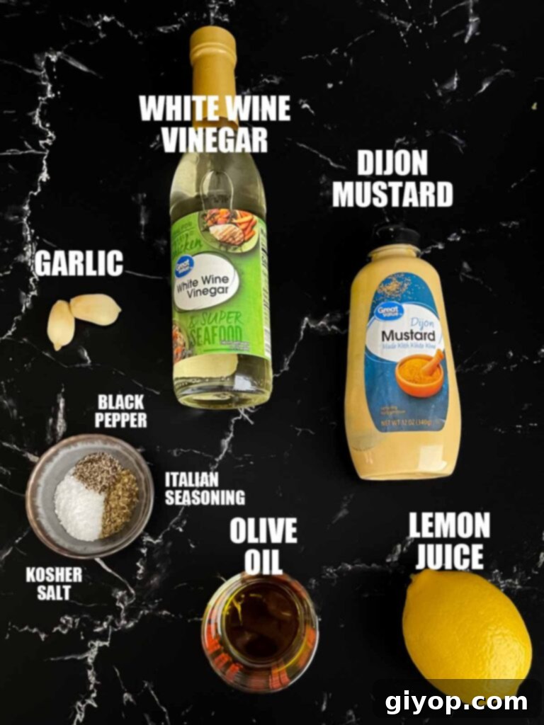 Individual ingredients for the lemon herb dressing, including olive oil, lemon, herbs, and spices, meticulously arranged on a dark surface.