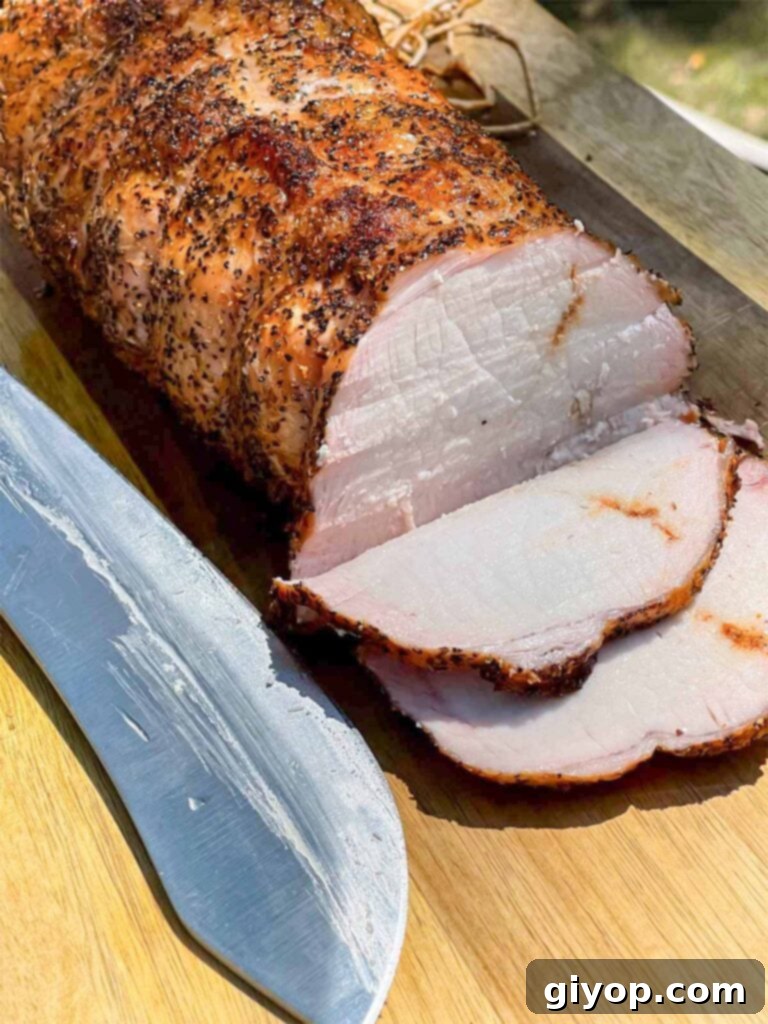 Texan Pit Smoked Pork Loin 9 A Texas style smoked pork loin on cutting board with some slices.