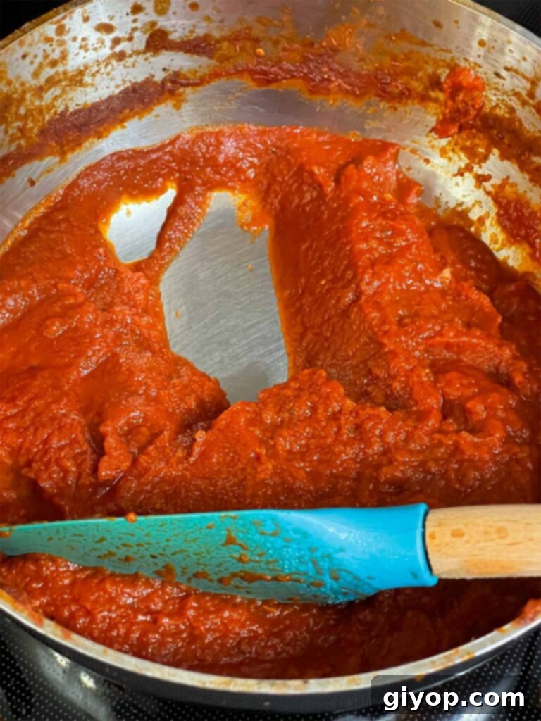 A thickened calzone dipping sauce in a saucepan, ready for use.