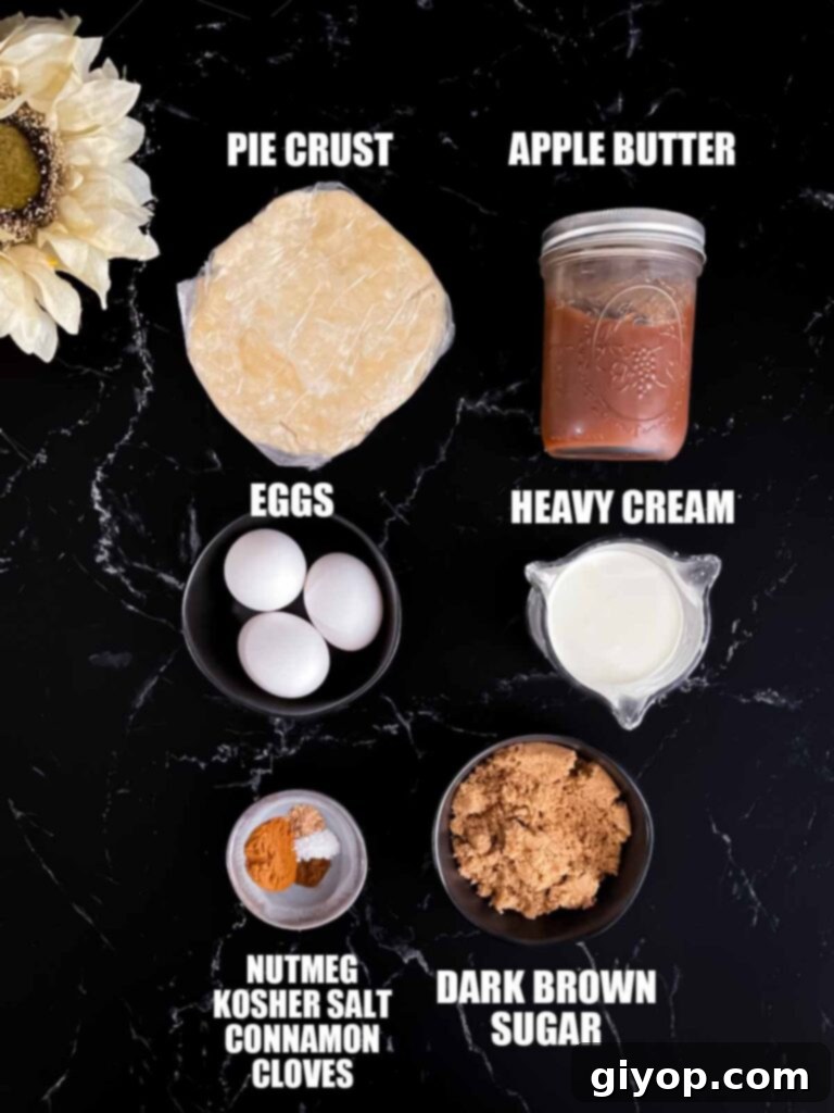 A collection of fresh ingredients laid out on a table, including a jar of apple butter, eggs, heavy cream, brown sugar, and various spices, ready to be combined for the pie.