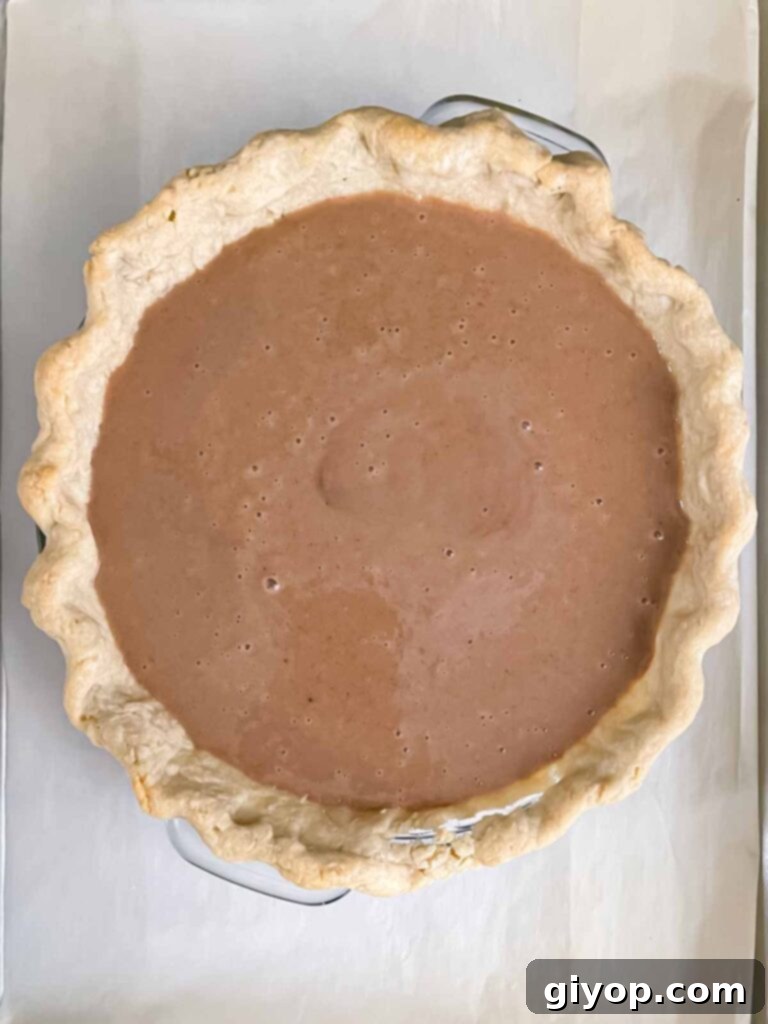 A freshly baked Apple Butter Pie, golden brown and perfectly set, cooling on a wire rack with a baking sheet underneath.