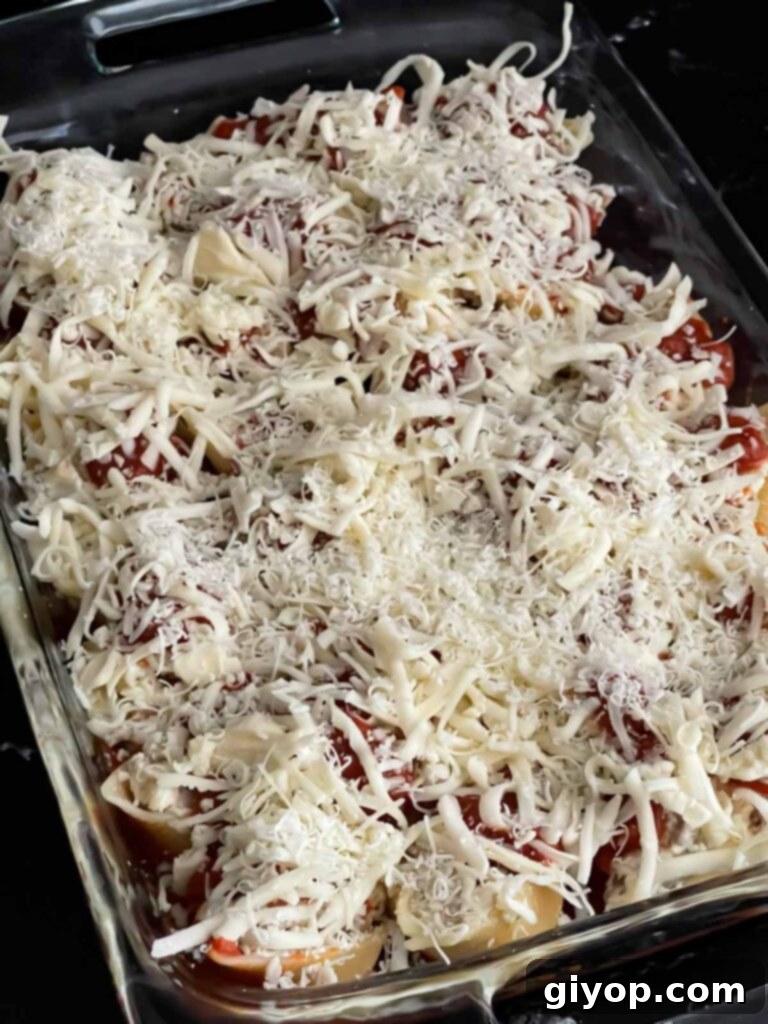 Unbaked Italian sausage stuffed shells ready to go into the oven.