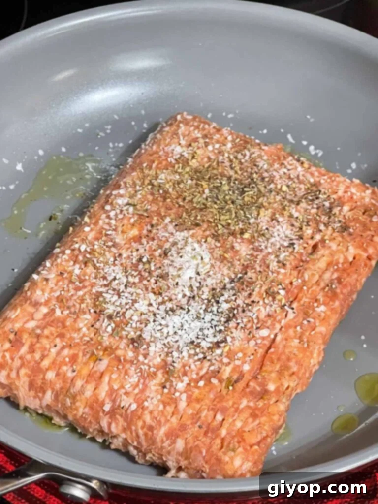 Seasoned Italian sausage in a skillet.