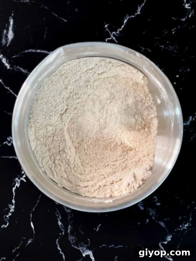 Dry ingredients whisked together in a metal bowl for the zucchini bread recipe.
