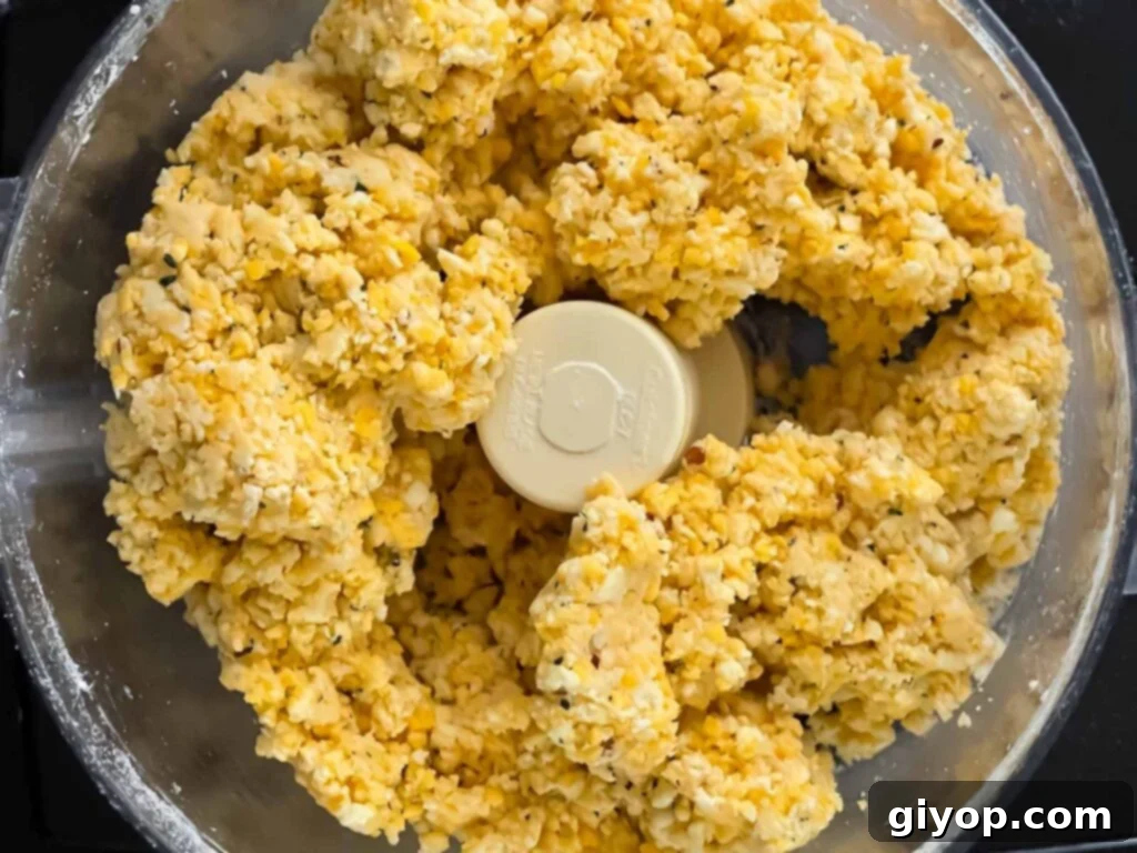 Savory Cheddar Herb Twists 8 A perfectly formed cheese straw dough ball in the food processor, signaling it's ready for rolling.