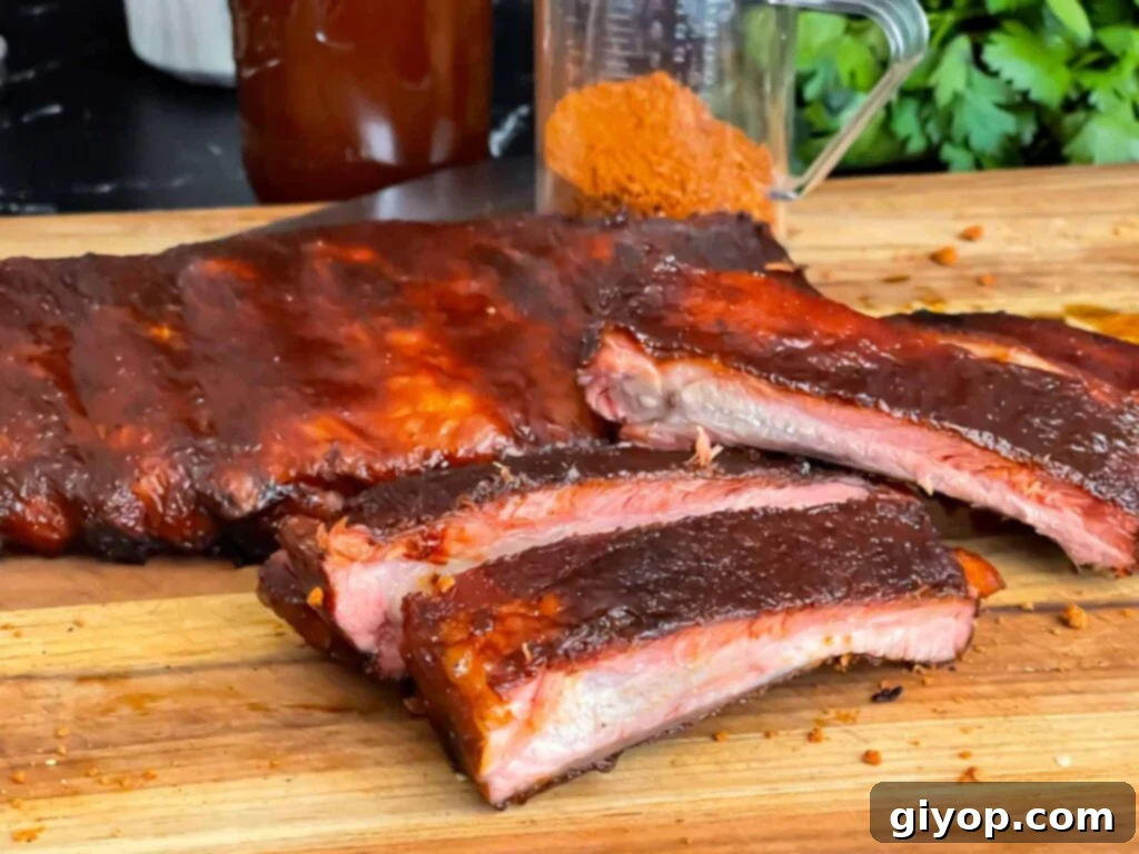 Legendary Kansas City Barbecue Sauce 9 Perfectly cooked Kansas City style ribs on a wooden cutting board, glazed with barbecue sauce and garnished.