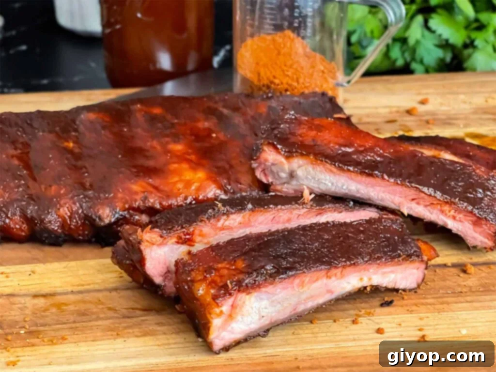 Smoky, sticky Kansas City style ribs on a cutting board, ready to be served.