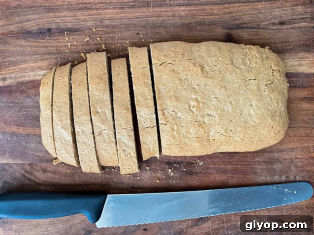 The process of cutting chai biscotti into individual cookies.