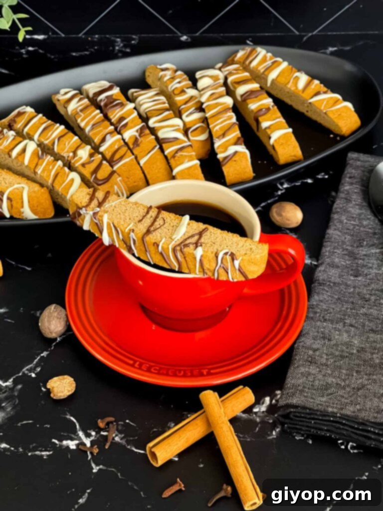 Chai biscotti served on a dark plate with a cup of coffee, ready to be enjoyed.