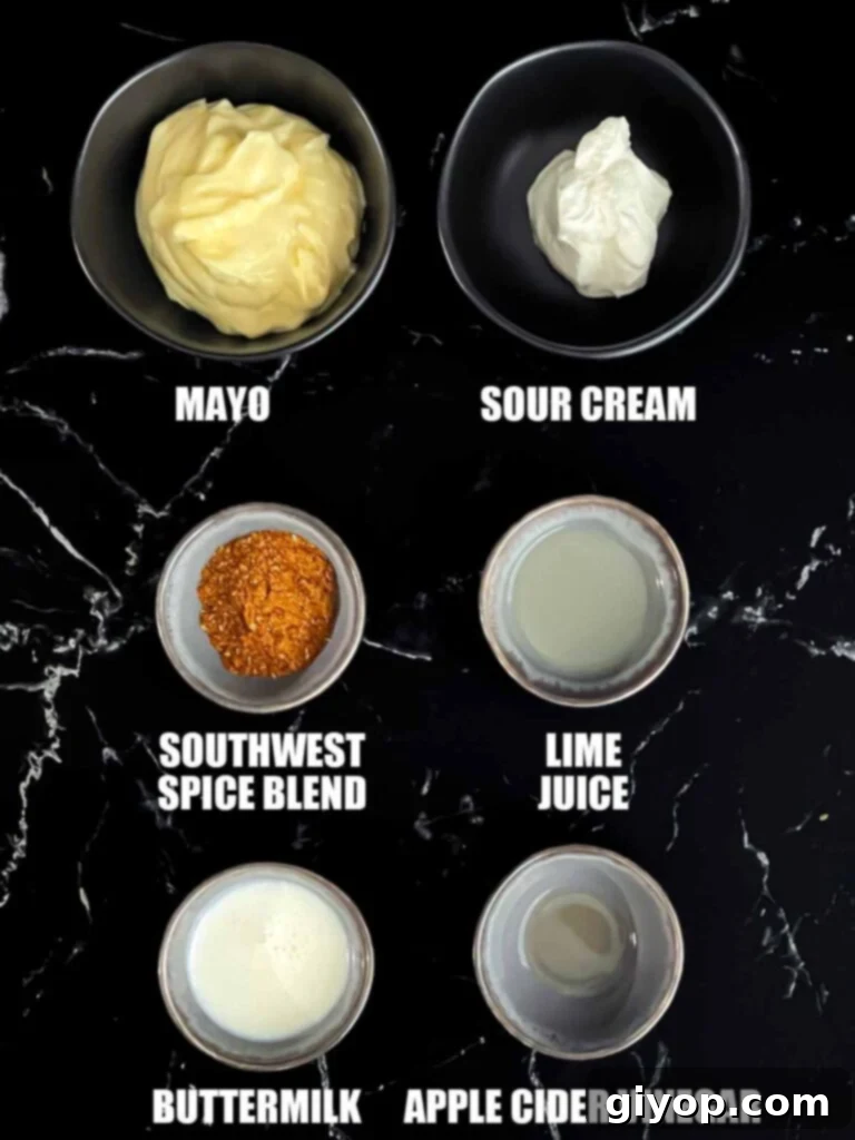 A collection of fresh ingredients laid out for preparing a creamy southwest sauce, including spices, sour cream, and lime.