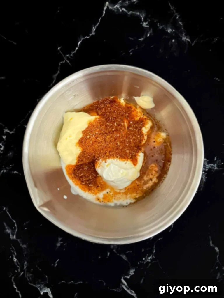 All creamy southwest sauce ingredients gathered in a mixing bowl before whisking.