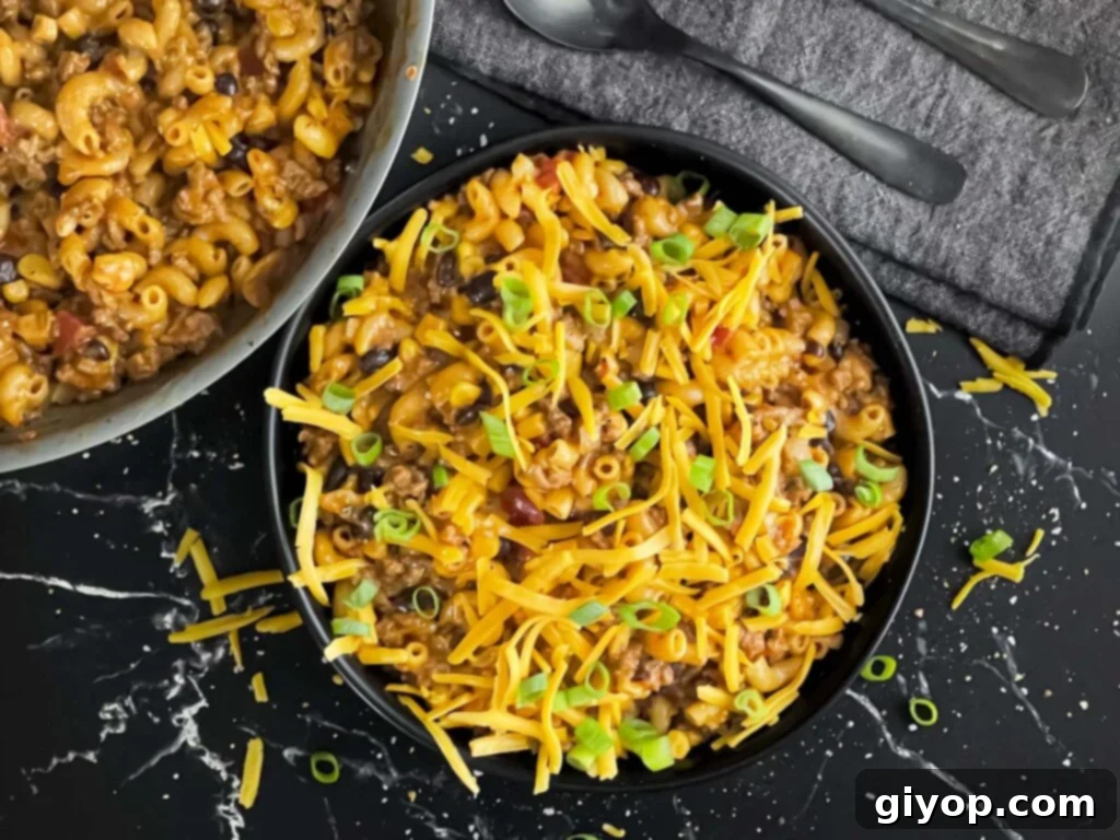 A delicious one-pot taco pasta skillet dinner served in a dark bowl, ready to be enjoyed.