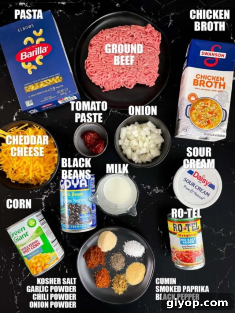 A display of fresh ingredients required to prepare the savory Taco pasta skillet, including ground beef, spices, vegetables, and pasta.