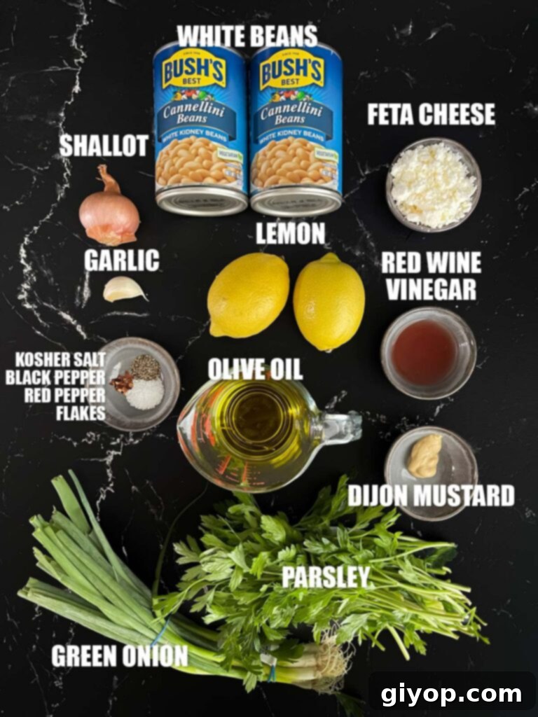 Bright Lemon White Bean Salad 3 All the fresh ingredients laid out on a dark surface, ready to be combined for the lemon white bean salad.