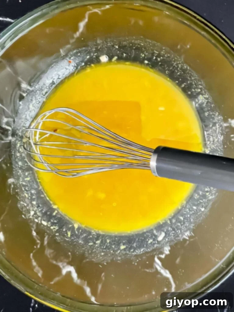 Bright Lemon White Bean Salad 5 A simple, emulsified lemon dressing in a glass bowl, perfectly mixed and ready for the salad ingredients.