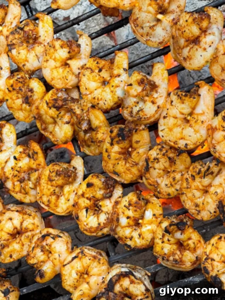 Shrimp cooking on a hot grill, turning pink and opaque.