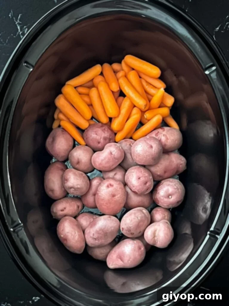 Carrots and potatoes in a crock pot.