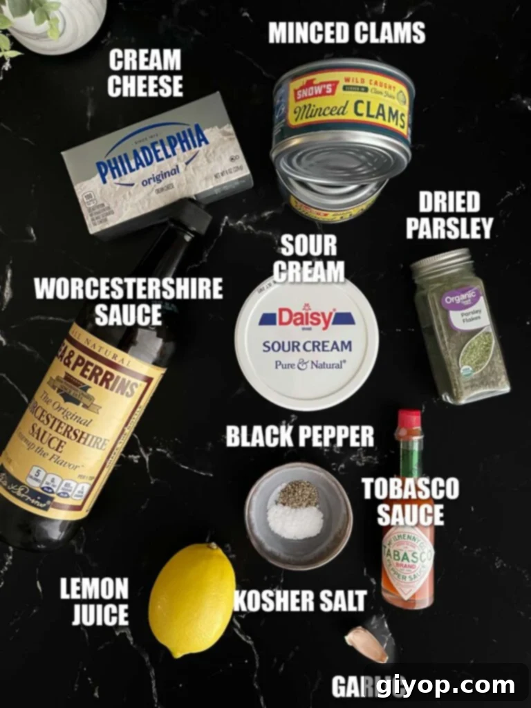All the fresh ingredients for the clam dip recipe laid out on a dark surface, including cream cheese, sour cream, canned clams, garlic, and seasonings.