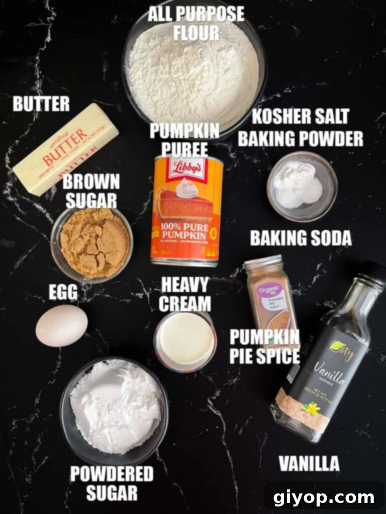 All the necessary ingredients for making pumpkin scones laid out neatly on a dark surface, showcasing vibrant pumpkin puree, dry spices, and fresh eggs.