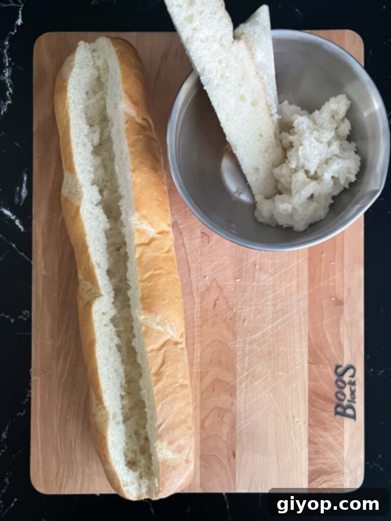 A hollowed-out French bread loaf, creating a perfect edible boat for the filling.