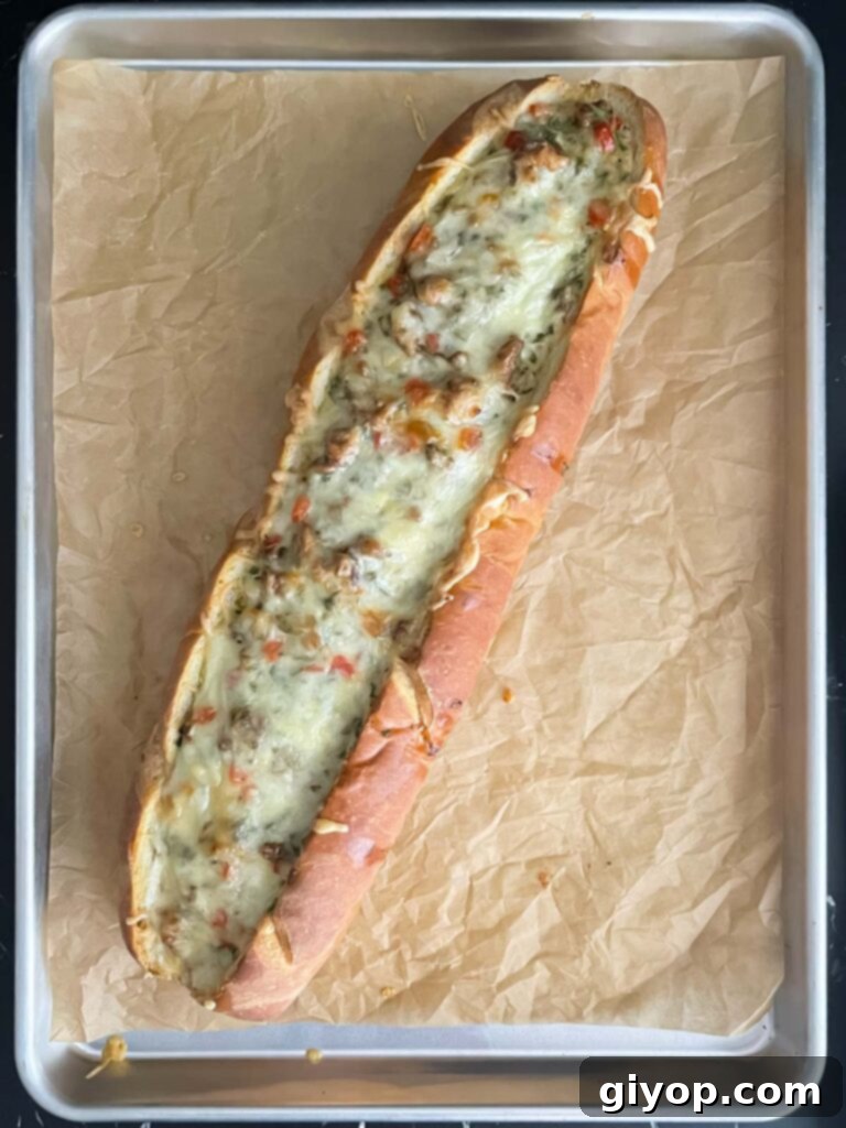 A freshly baked Sausage and Egg Baguette Bake, golden brown and hot out of the oven.