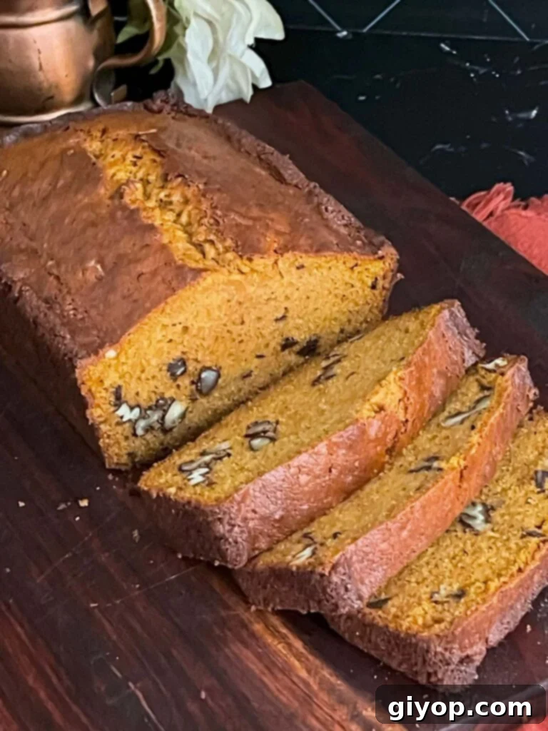 Sweet potato bread sliced on a wooden board, showcasing its moist interior.