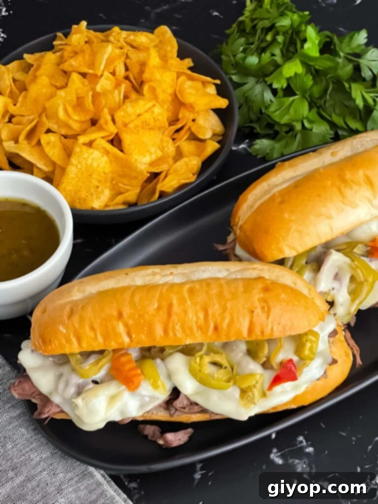 Classic Slow Cooker Italian Beef Sandwiches on a dark plate, ready to be served.
