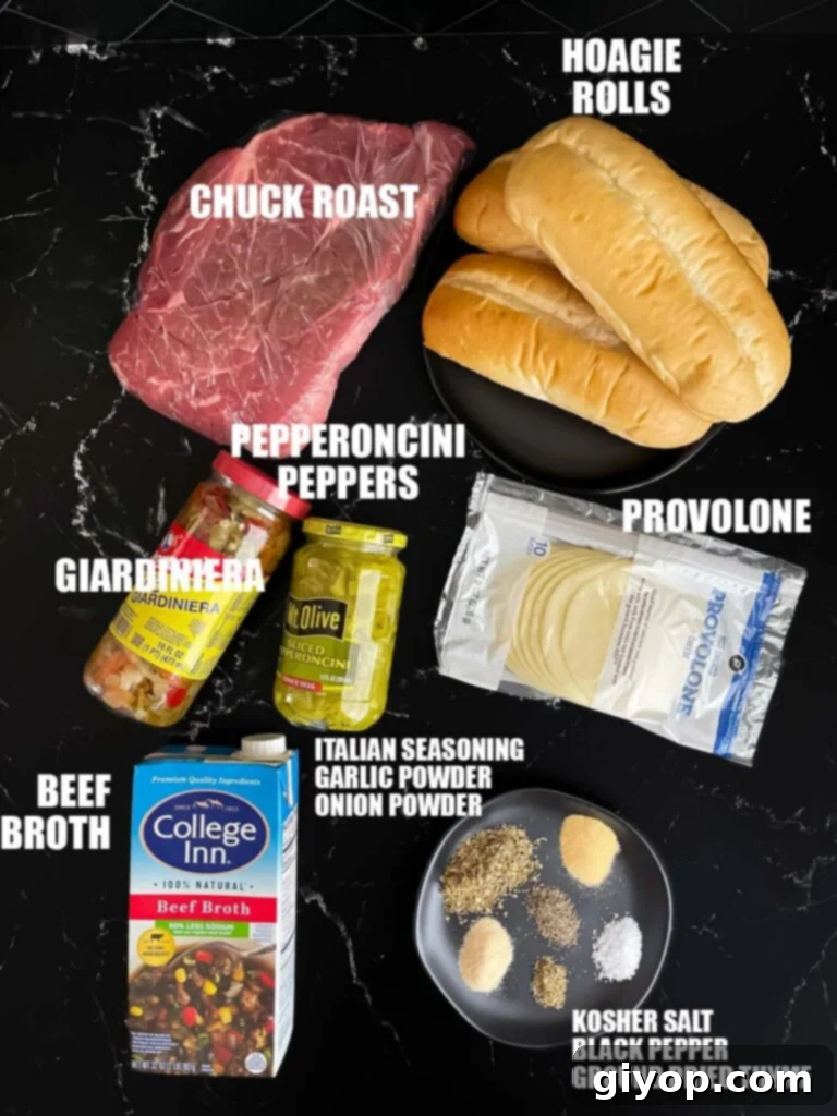 Essential ingredients for slow cooker Italian beef sandwiches laid out on a dark surface, including chuck roast, spices, pepperoncini, and giardiniera.