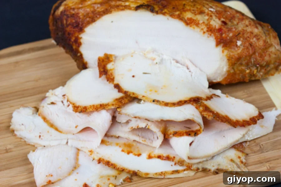 Artisan Cajun Turkey Deli Slices 2 Homemade cajun turkey deli meat sliced on a wooden cutting board.