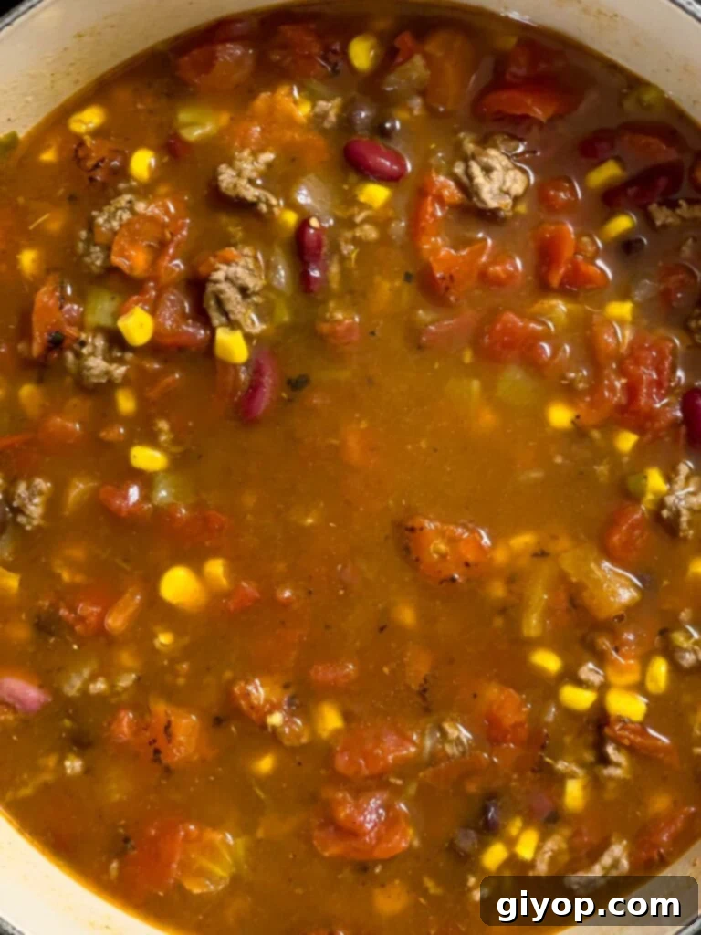 Taco soup simmering in a dutch oven on the stovetop.