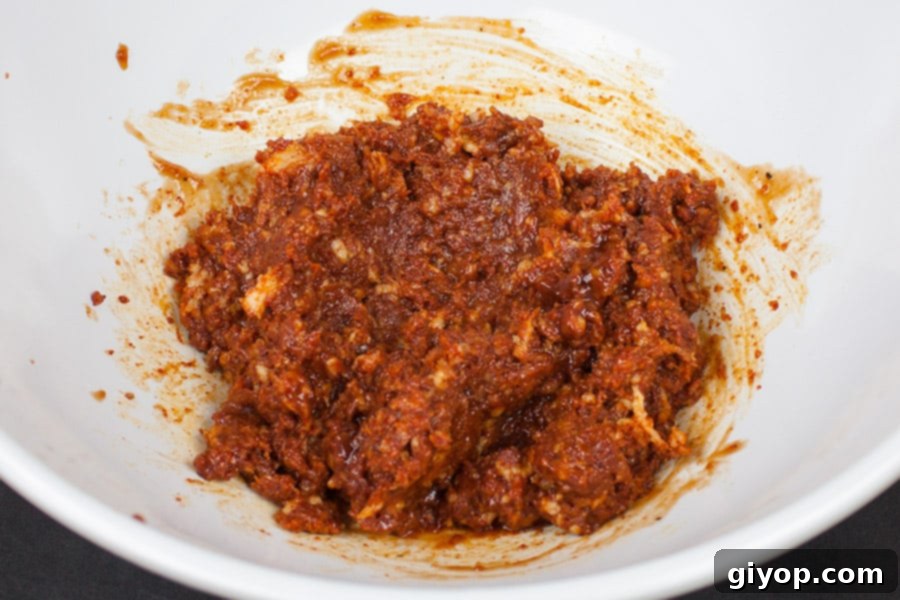 Smoky Bacon Glazed Chicken Kebabs 4 Smooth bacon paste mixed with barbecue sauce in a white mixing bowl, ready for chicken.