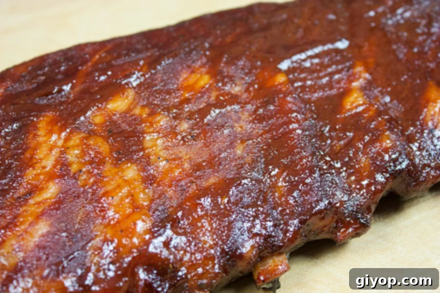 A rack of St Louis Style Ribs on a cutting board, cooked to perfection, showcasing its rich color and tender appearance.