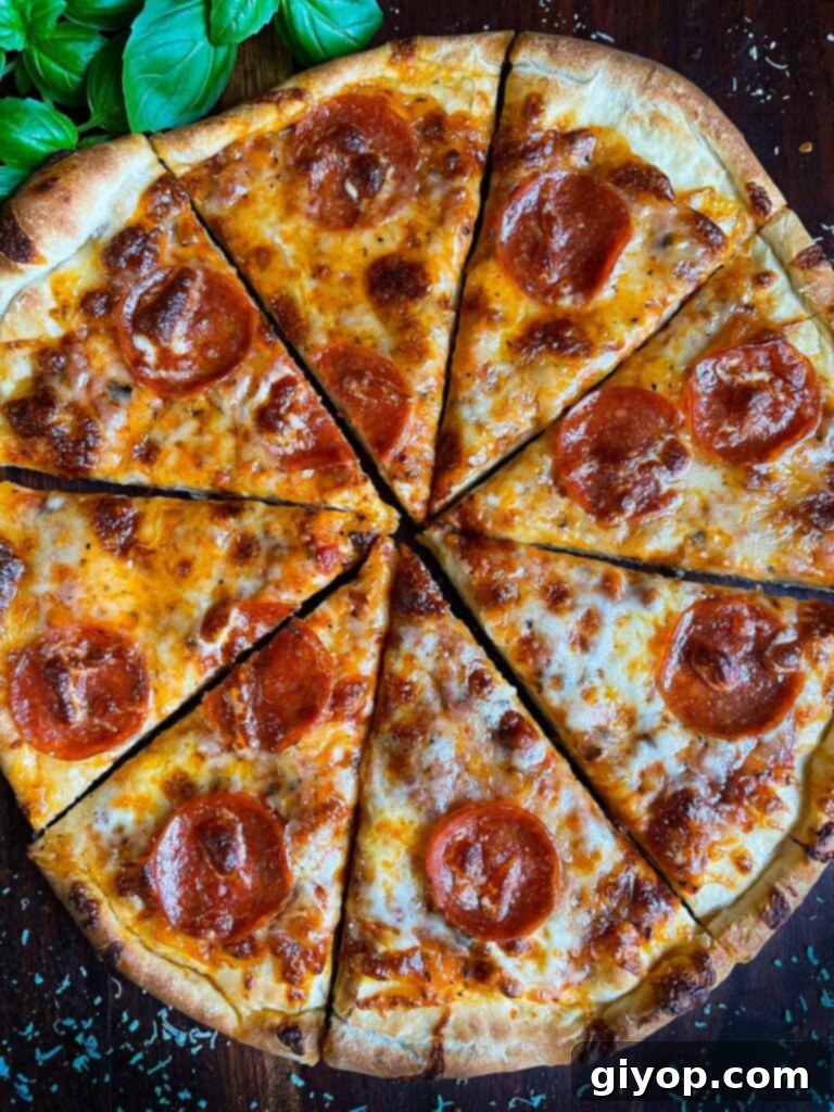 A homemade pepperoni pizza right out of the oven, sliced.