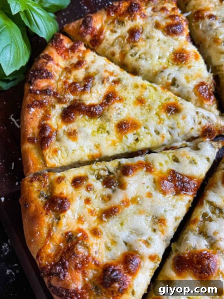 Homemade pesto and cheese pizza using homemade pizza dough.