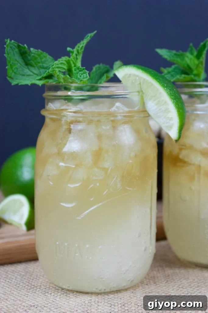 Bluegrass Bourbon Mule 2 Kentucky Mule served in a large mason jar garnished with fresh mint and a lime wedge.
