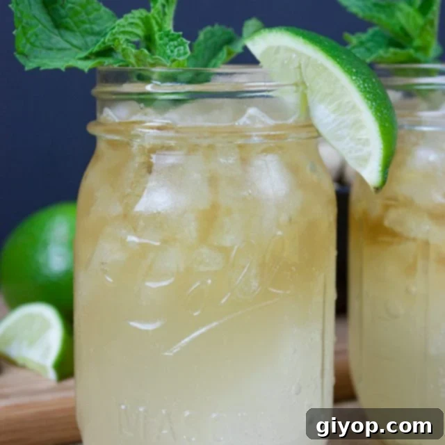 Bluegrass Bourbon Mule 3 Kentucky Mule served in a large mason jar garnished with fresh mint and a lime wedge.