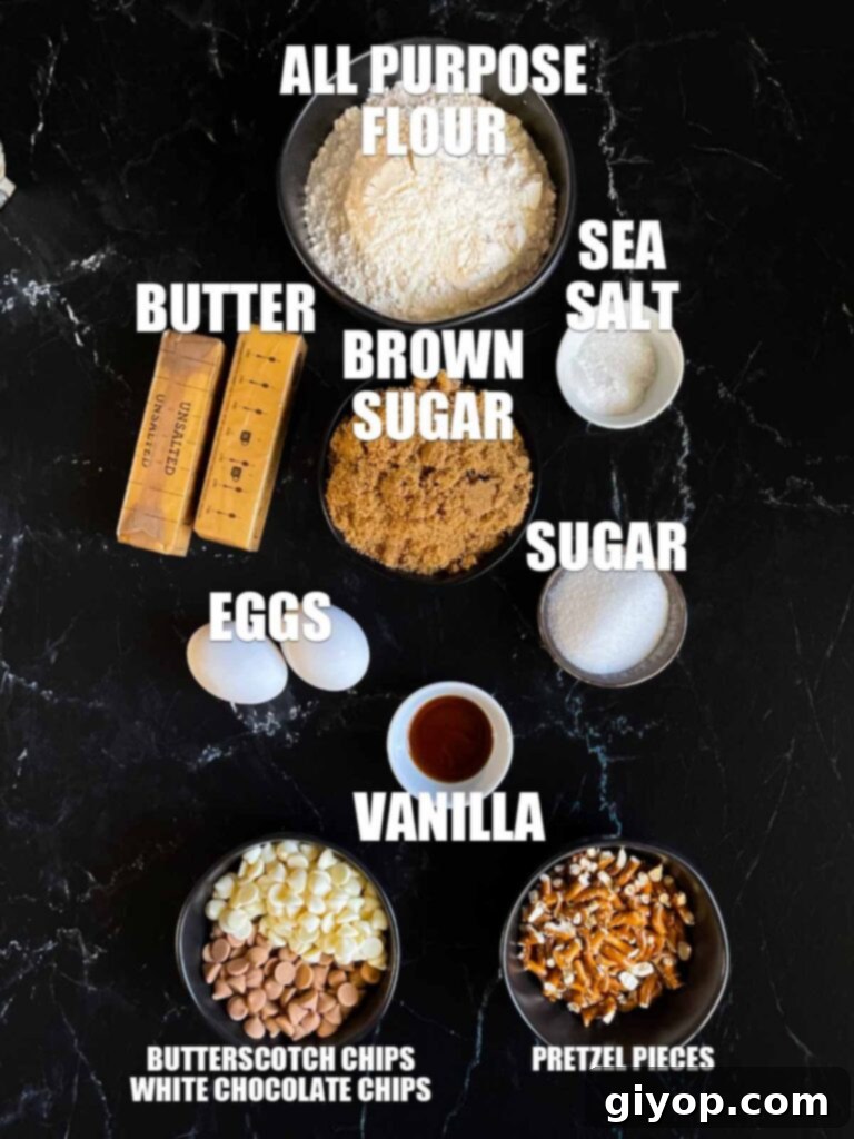 Ingredients for salted butterscotch pretzel cookies on a dark surface.