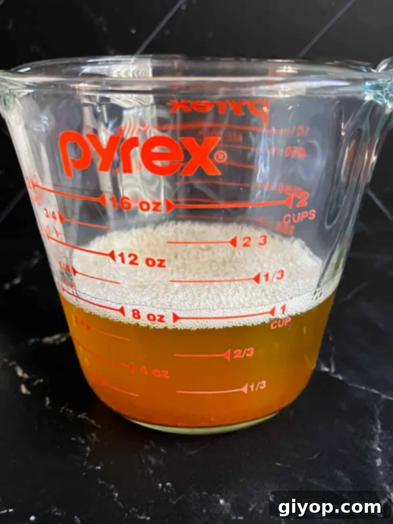 Melted brown butter in a measuring cup.