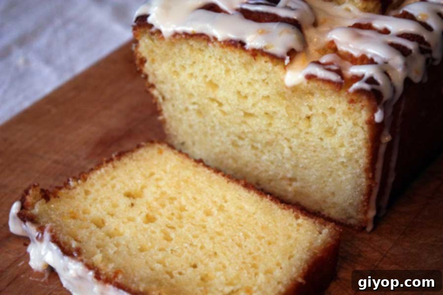 A perfectly sliced Meyer Lemon Loaf on a wooden board, ready for serving.