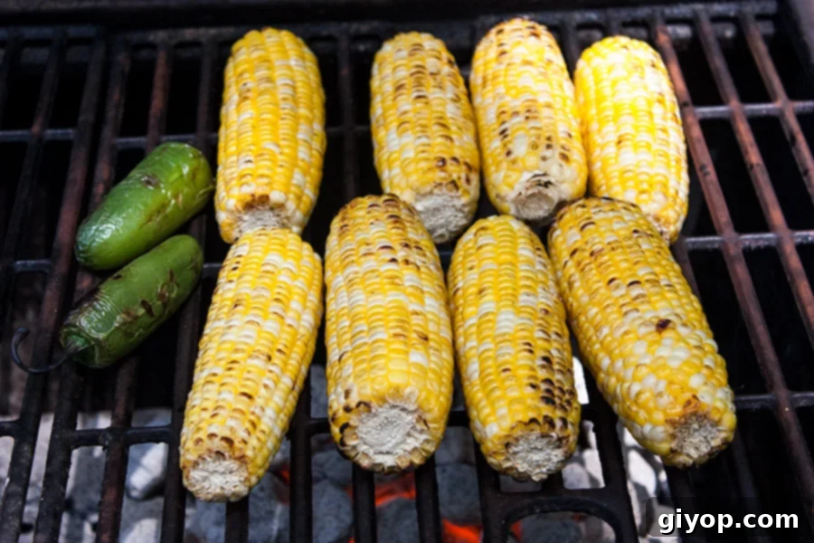 Grilled Mexican Street Corn Salad - corn cobs and jalapeños on the hot grill